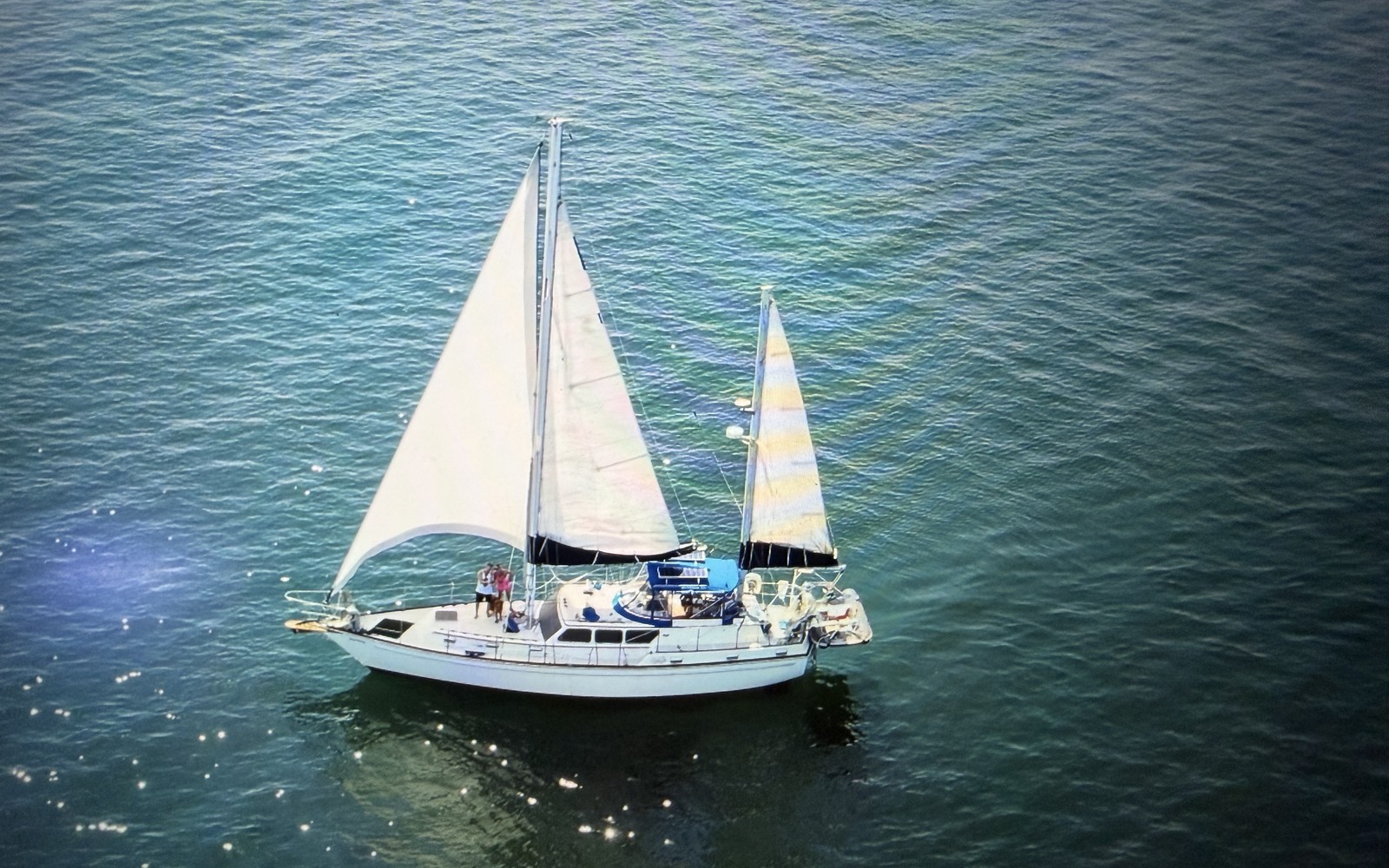 Sailboats reaching under full sail on a clear afternoon