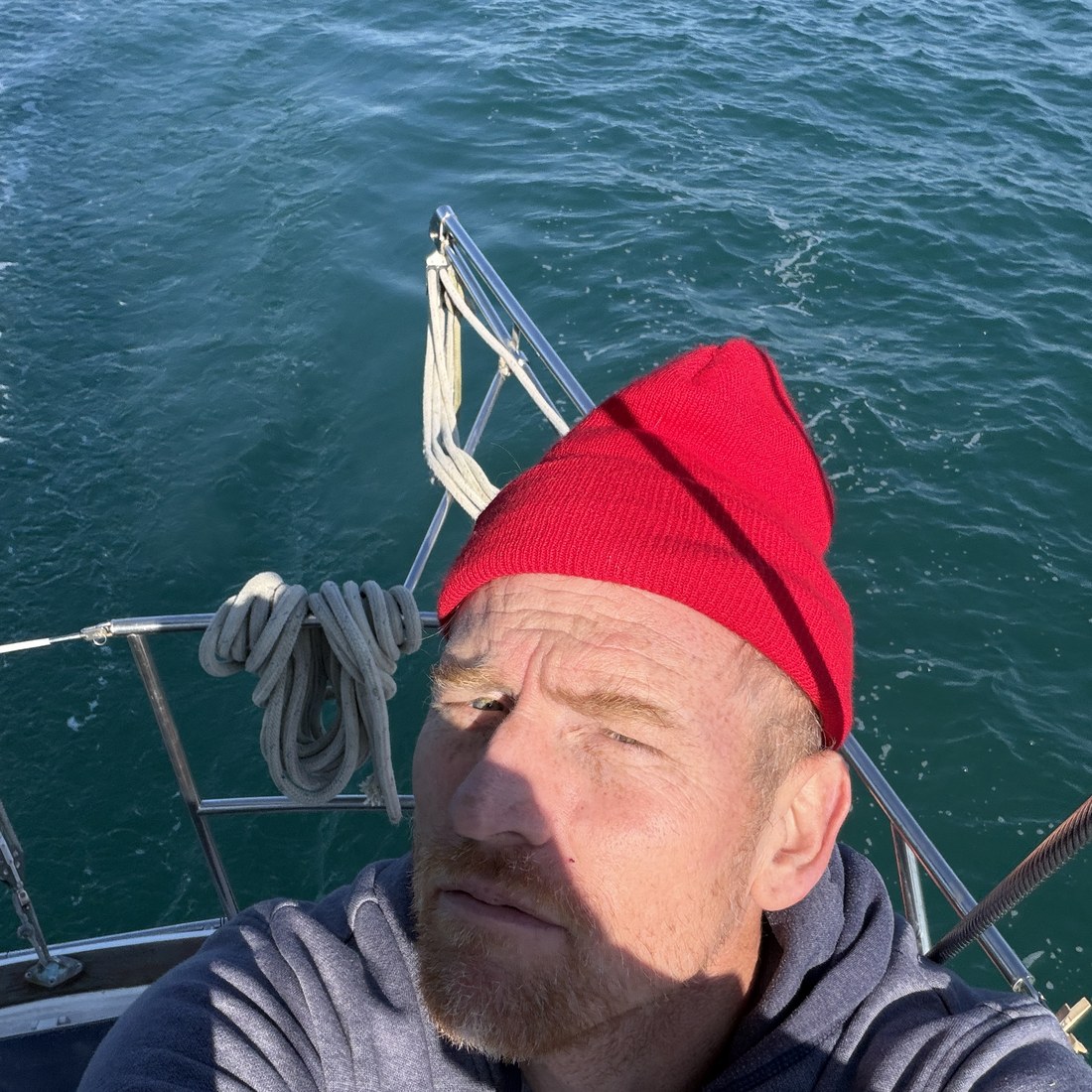 Jason on deck with open water behind him