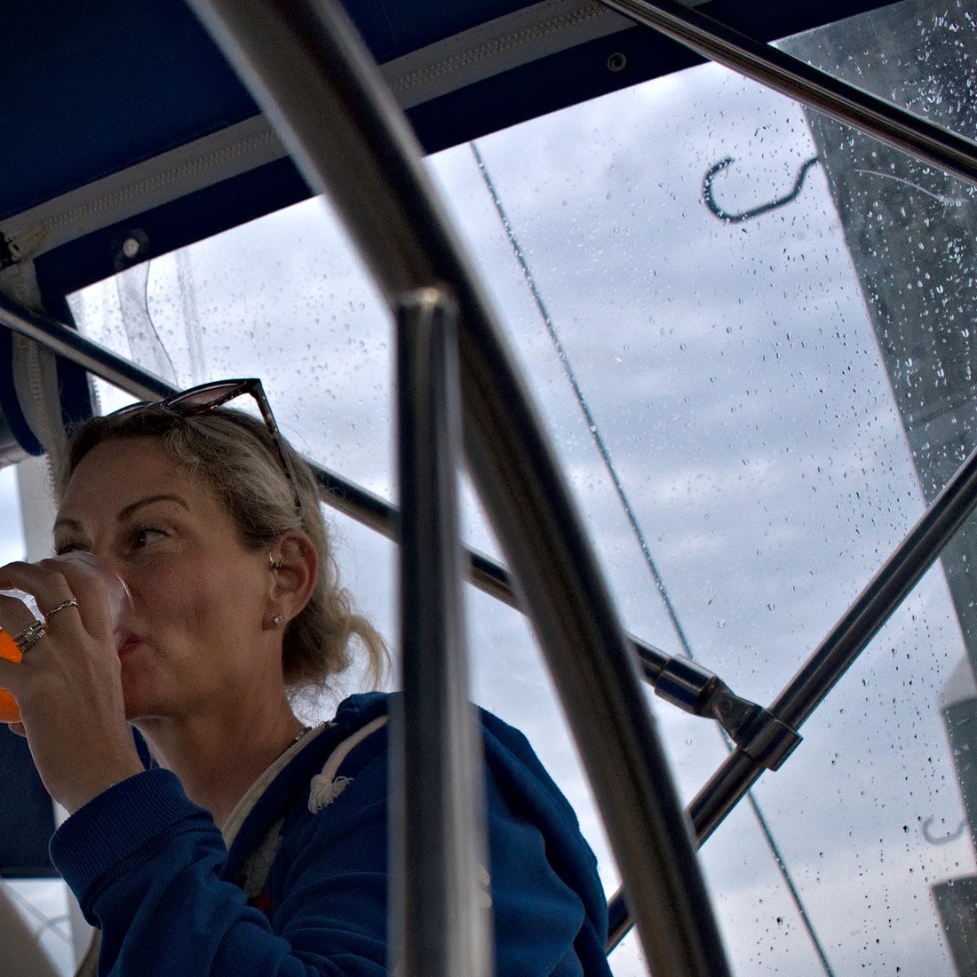 Jayme staying warm under the cockpit enclosure on a rainy day