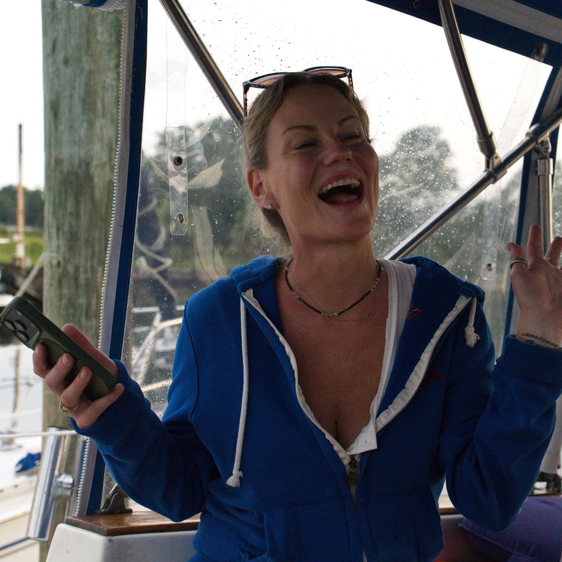 Jayme laughing on a sunny day at the marina